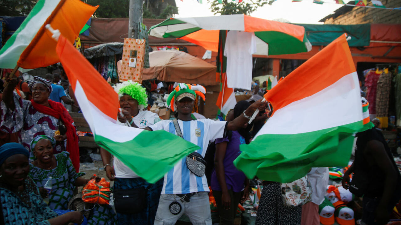 Man carry Ivorian flags on the street