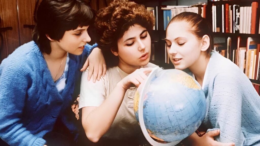 The Polgar sisters looking at the world map