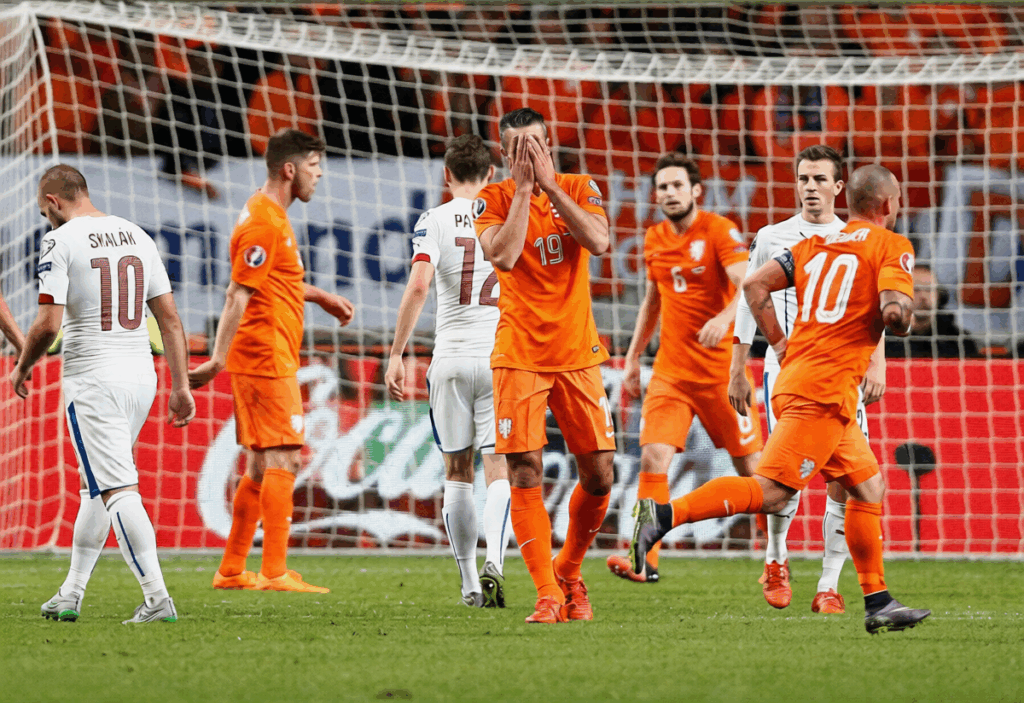 Van Persie covers his face after scoring an own goal against Czech Republic during the 2016 Euros qualifications
