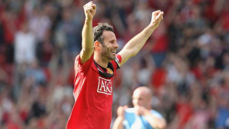 Ryan Giggs with arms up in the air after a victorious win.