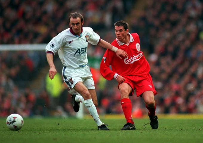 Jamie Carragher trying to win a ball over during his playing days at Liverpool