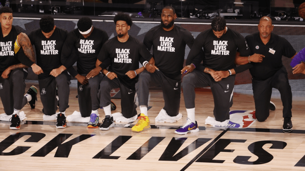 NBA players protest racial injustice as league returns to action.