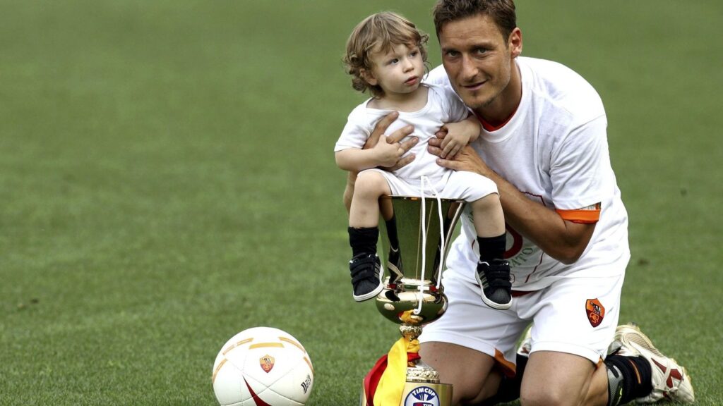 Francesco Totti, Roma's greatest one club man holding a trophy with his child