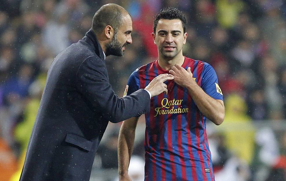 Xavi Hernandez taking instructions from Guardiola during his playing days 