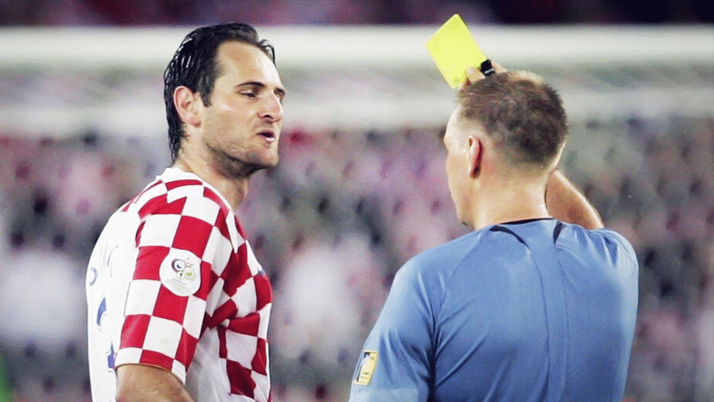 Josip Simunic recieving the first of his three yellow cards from referee Graham Poll