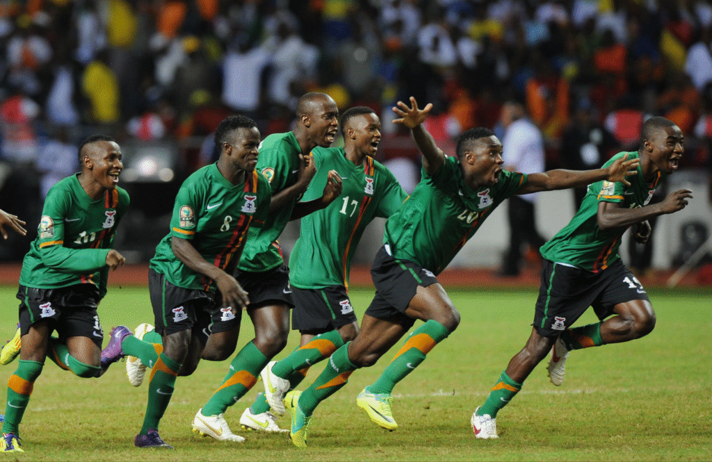 Zambian players celebrate winning a penalty shootout