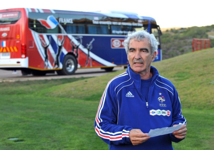 France coach Raymond Domenech reading the players' strike statement with the team bus in the background