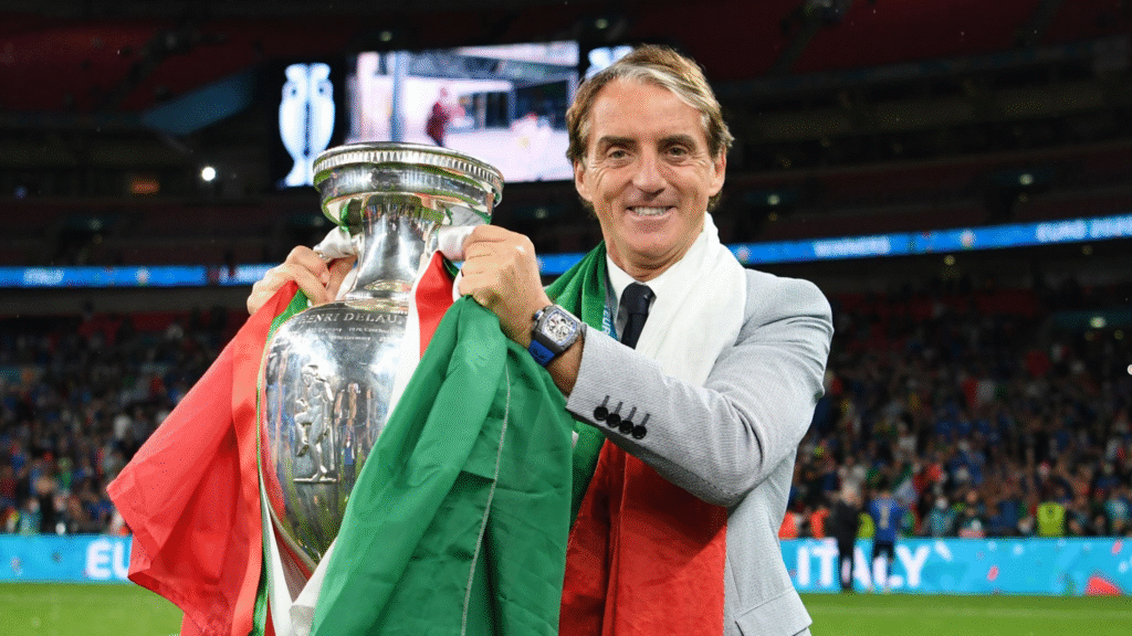 Roberto Mancini poses with the Euros trophy in Wembley