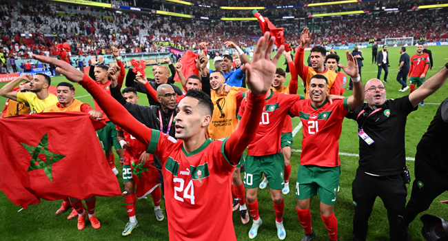 Morocco players celebrate qualifying to the knockout stages of the 2022 FIFA World Cup