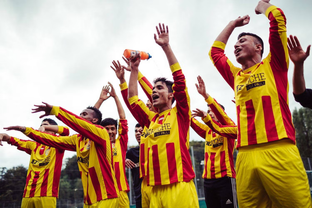 Players of FC Lampedusa celebrate after a victory