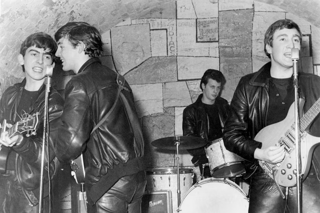 The Beatles performing during a live show