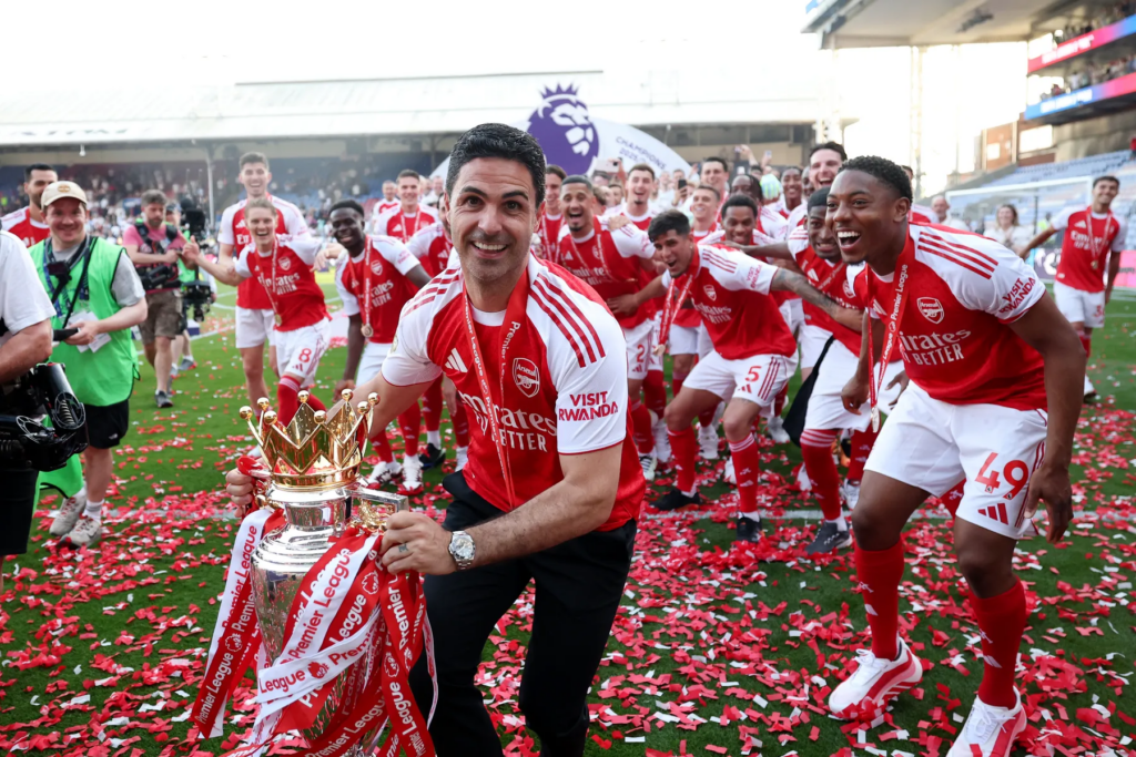 Arsenal manager Mikel Arteta celebrates with the Premier League trophy in 2026