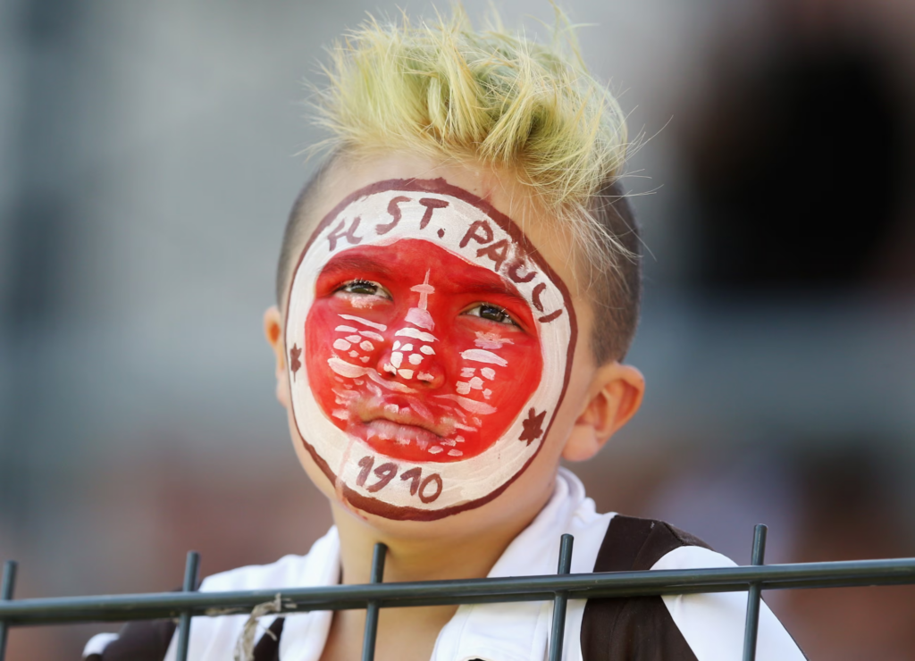 A young St. Pauli with a face art of the club's badge