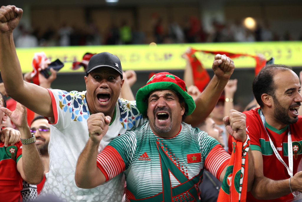 Excited Morocco fans celebrating during a match at the 2022 World Cup in Qatar