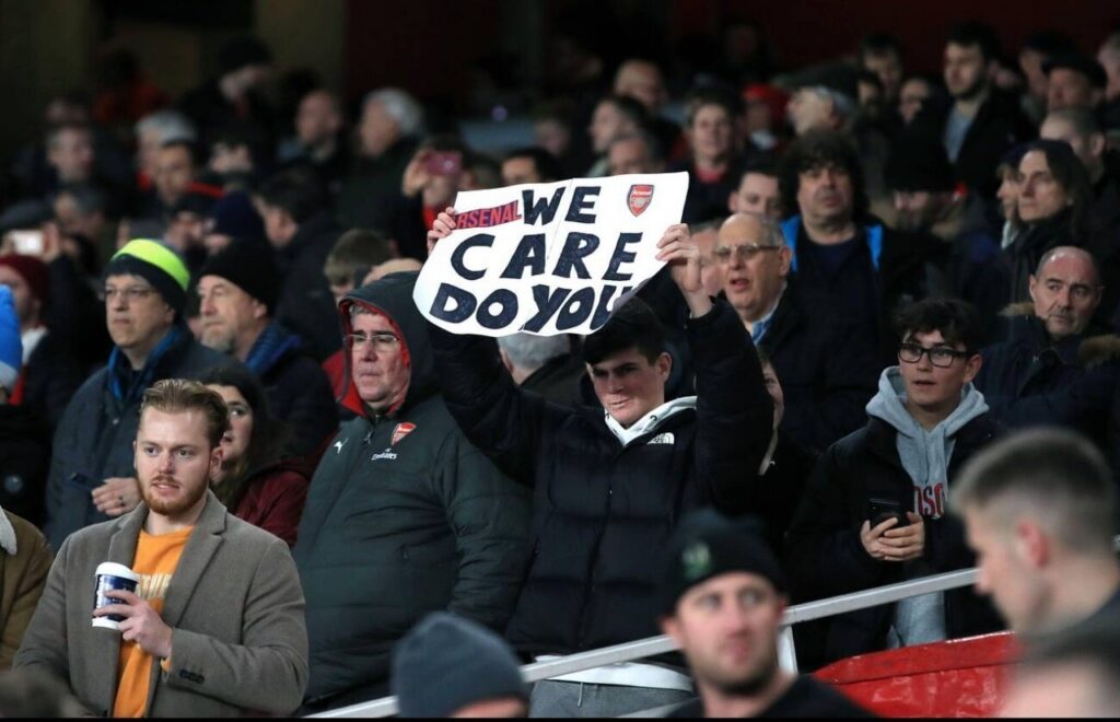Aggrieved Arsenal fans holding a banner expressing their displeasure at ownership