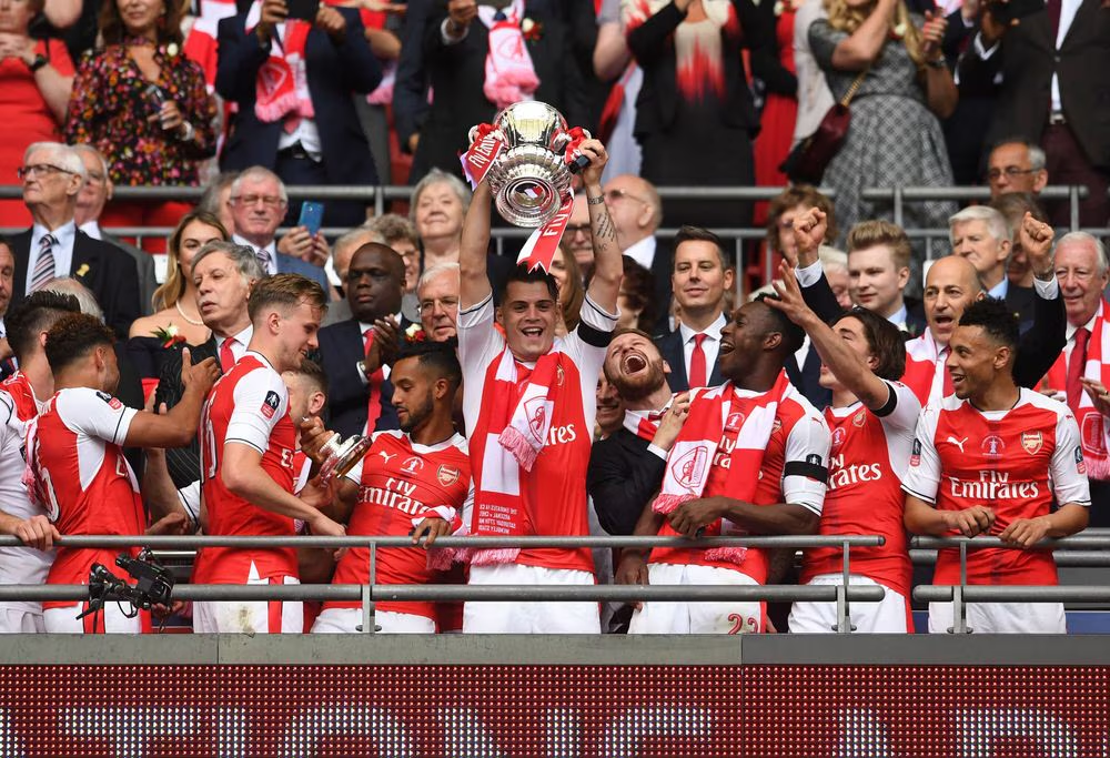 Xhaka lifting the FA Cup trophy in 2017 with his teammates