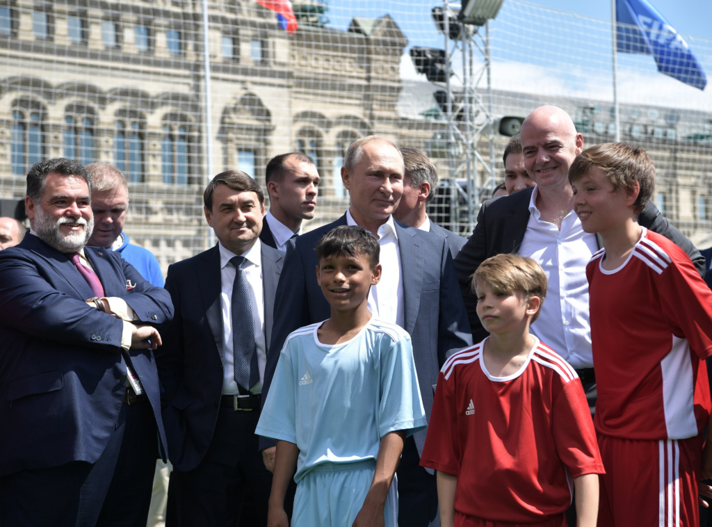 Vladmir Putin Russia's President and Infantino posing with little children for a photograph 