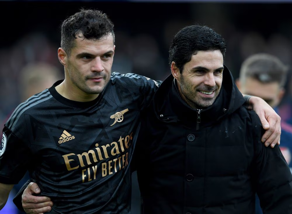 Mikel Arteta, holding Xhaka closely after a match in 2022