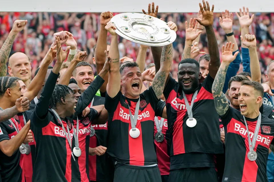 Xhaka and his teammates lift the Bundesliga trophy in 2024