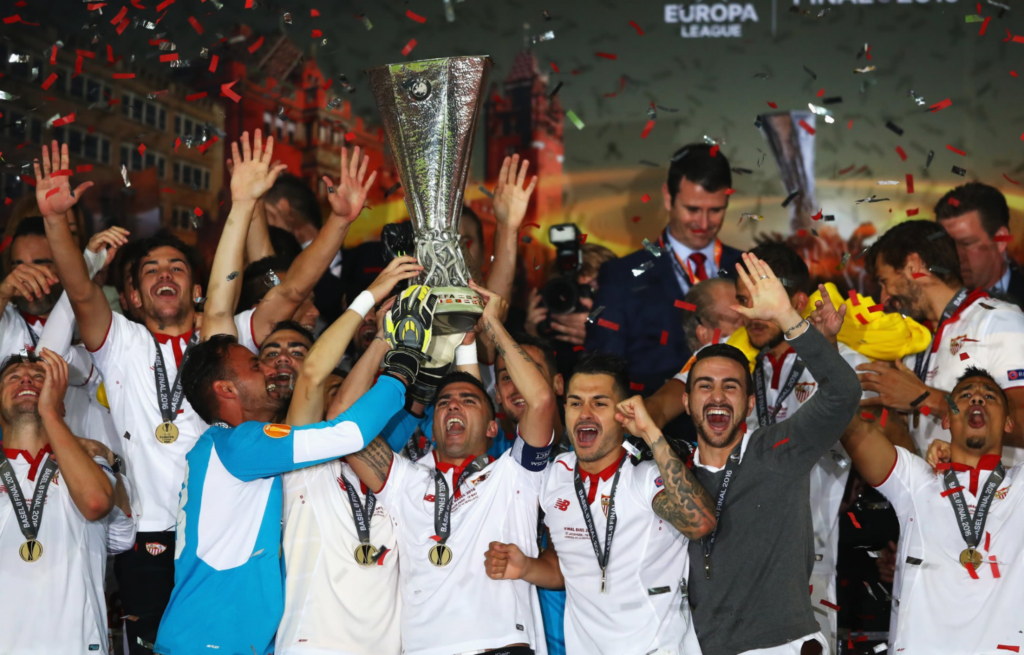 Sevilla players celebrate with the Europa League trophy in 2016