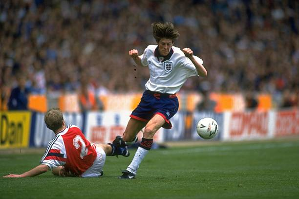 England's Paul Ince fights for the ball with Norway's Lars Bohinen as Norway defeats England 2-0 at the 1994 FIFA World Cup qualifier.